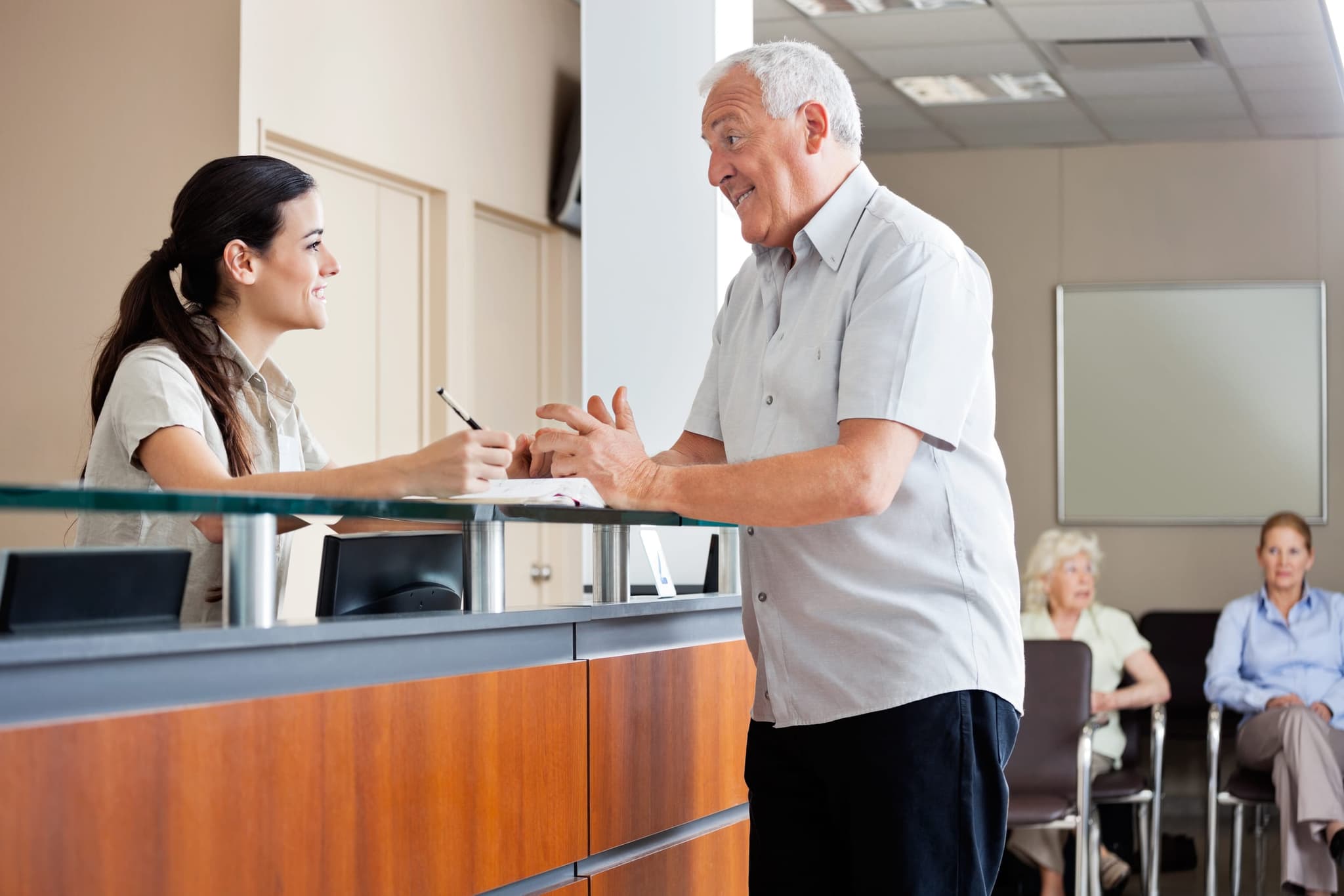 A welcoming reception area at a California Renal Care clinic, with a friendly staff member ready to check patients in
